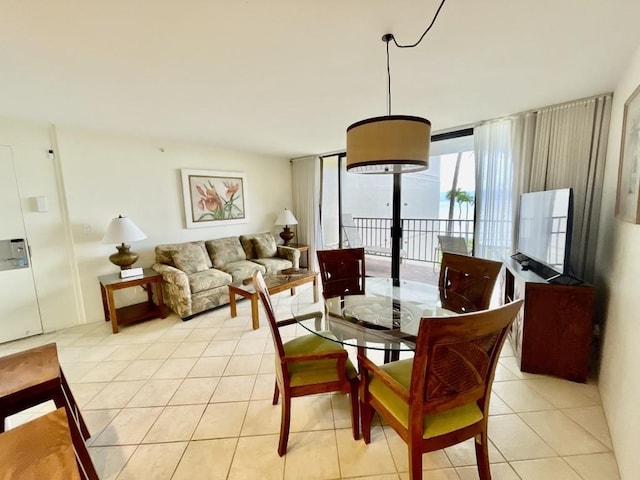 dining room with floor to ceiling windows and light tile patterned floors