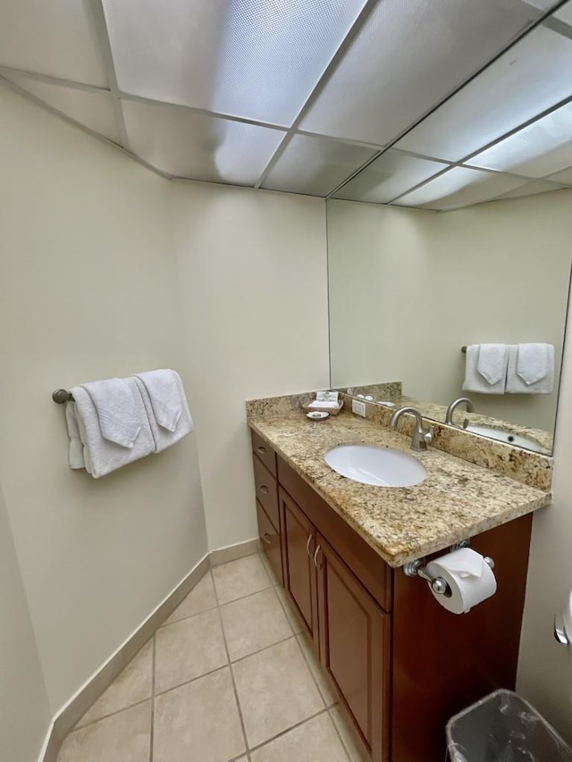 bathroom featuring a drop ceiling, vanity, and tile patterned flooring