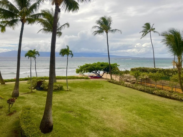 exterior space with a lawn and a water and mountain view