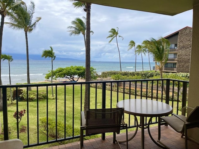 balcony featuring a water view and a beach view