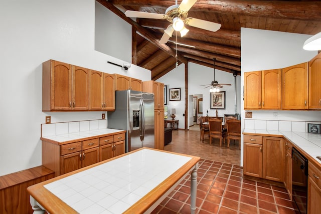 1160 Ehu Rd, Makawao, HI 96768 - kitchen with tile counters, stainless steel fridge with ice dispenser, black dishwasher, ceiling fan, and a wooden ceiling with exposed beams