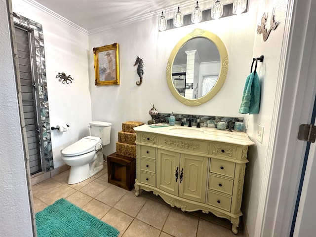 bathroom featuring tile patterned floors, vanity, toilet, and crown molding