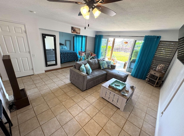 tiled living room with ceiling fan and a textured ceiling