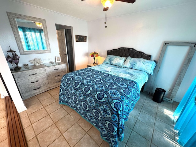 tiled bedroom with ceiling fan and crown molding