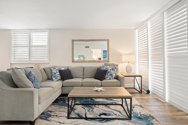 living area featuring baseboards and wood finished floors