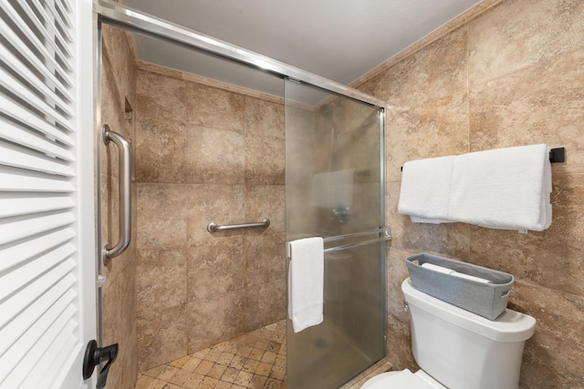 bathroom featuring a shower stall and toilet