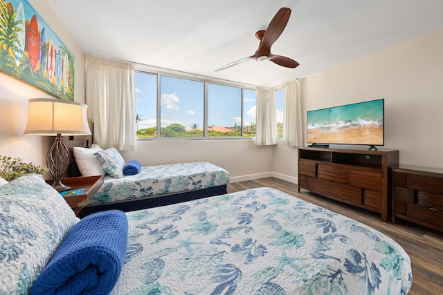 bedroom featuring baseboards, ceiling fan, and wood finished floors