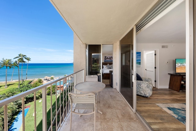 balcony with a water view and visible vents