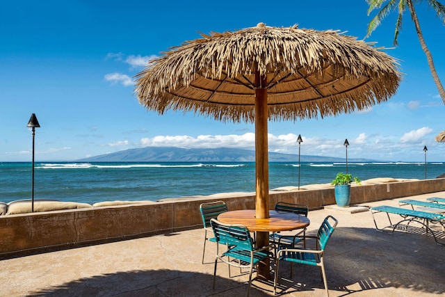 view of patio with a water and mountain view