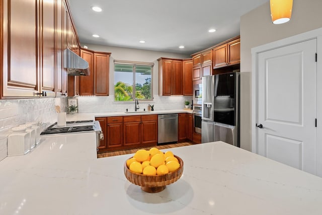 kitchen featuring a sink, tasteful backsplash, ventilation hood, recessed lighting, and appliances with stainless steel finishes