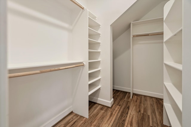 spacious closet with vaulted ceiling and wood finished floors