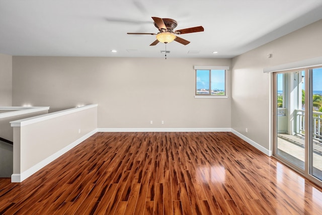 empty room featuring recessed lighting, ceiling fan, baseboards, and wood finished floors