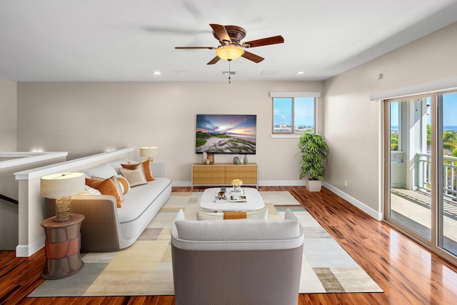 living room featuring recessed lighting, baseboards, wood finished floors, and a ceiling fan