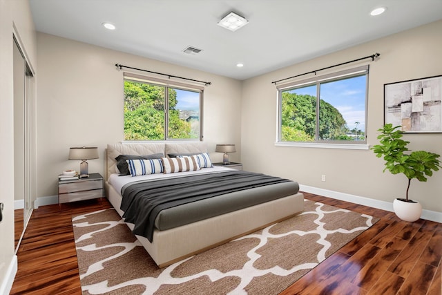 bedroom featuring recessed lighting, visible vents, multiple windows, and wood finished floors