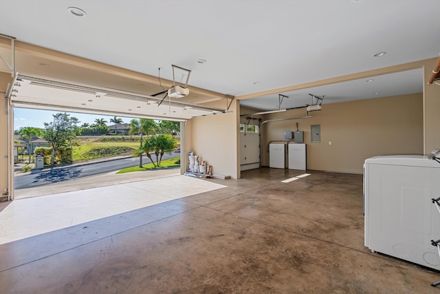 garage with electric panel, washer / clothes dryer, and a garage door opener