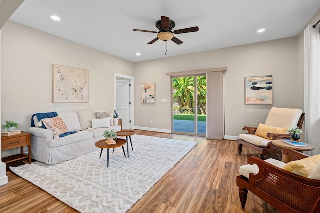 living room with recessed lighting, a ceiling fan, light wood-type flooring, and baseboards