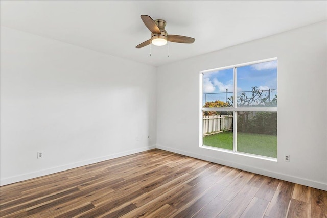 empty room with ceiling fan and wood-type flooring