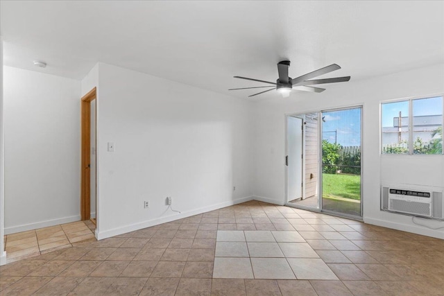 spare room featuring a wall mounted air conditioner, ceiling fan, and light tile patterned flooring