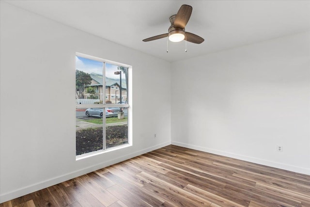 unfurnished room with hardwood / wood-style floors, plenty of natural light, and ceiling fan