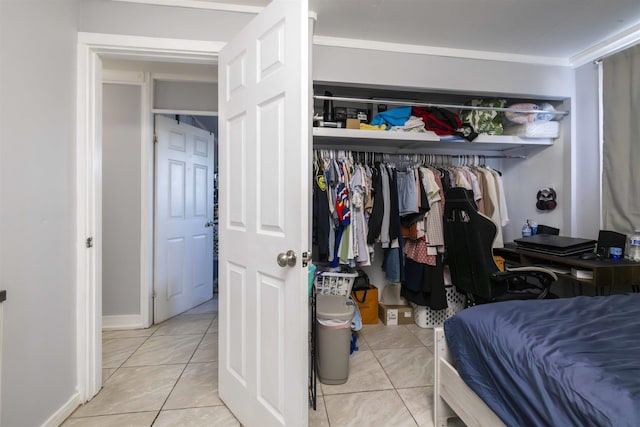 bedroom featuring a closet and light tile patterned floors