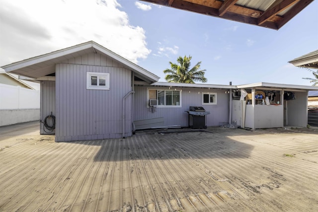 back of property featuring a wooden deck
