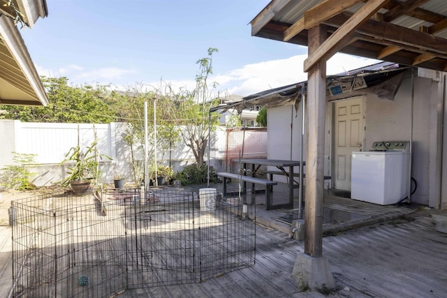 view of patio featuring fence, washer / clothes dryer, and a deck