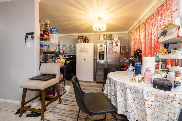 kitchen with crown molding, a notable chandelier, range, freestanding refrigerator, and stainless steel refrigerator with ice dispenser