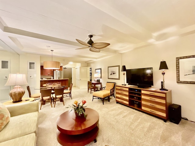 living room featuring beamed ceiling, light carpet, and ceiling fan