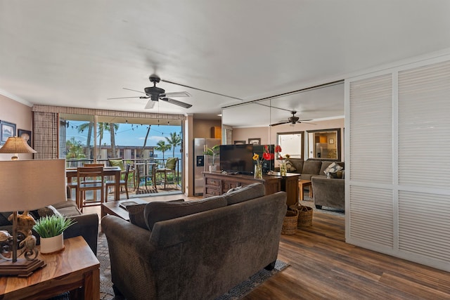 living room with ceiling fan, dark hardwood / wood-style floors, and ornamental molding