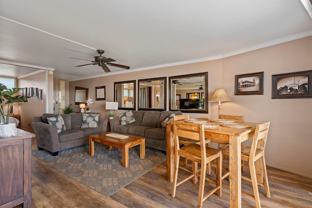 living room with crown molding, dark hardwood / wood-style flooring, and ceiling fan