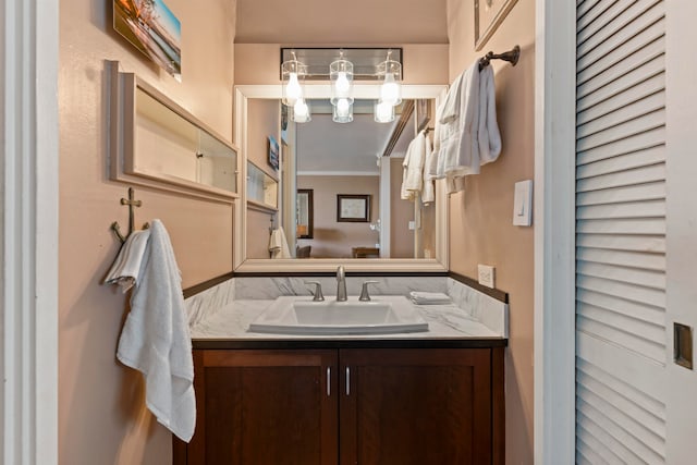 bathroom with vanity and ornamental molding