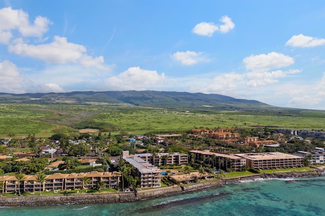 birds eye view of property with a water and mountain view