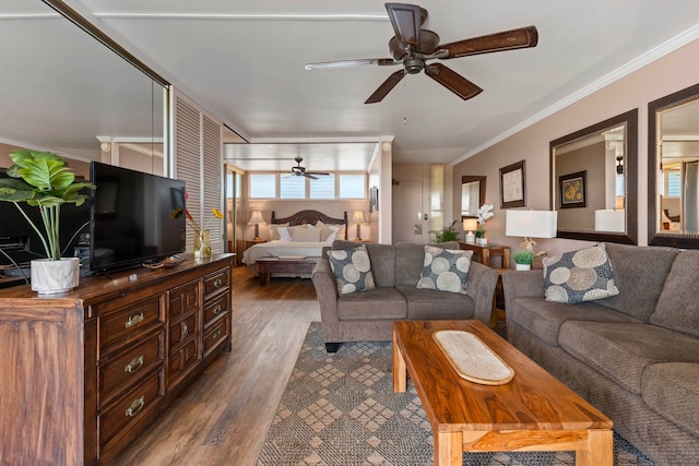 living room featuring dark hardwood / wood-style flooring, ceiling fan, and ornamental molding