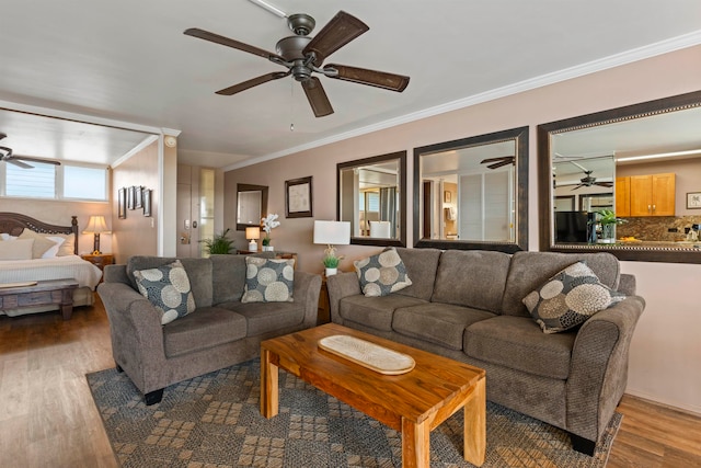 living room with crown molding, ceiling fan, and hardwood / wood-style flooring