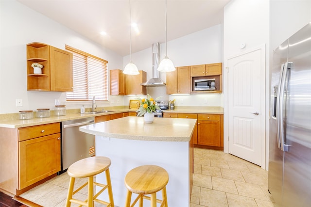 kitchen with appliances with stainless steel finishes, wall chimney exhaust hood, lofted ceiling, light countertops, and a kitchen breakfast bar