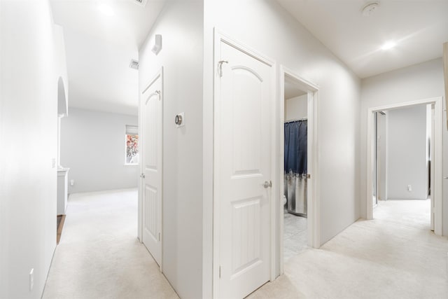 hallway with light colored carpet