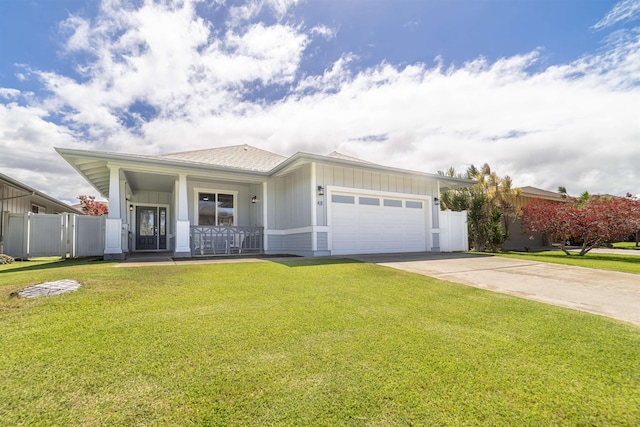 view of front facade featuring a garage, driveway, board and batten siding, and covered porch