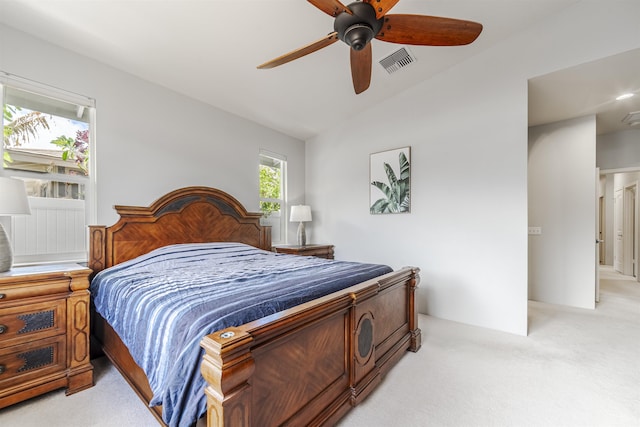 bedroom featuring light carpet, lofted ceiling, and a ceiling fan