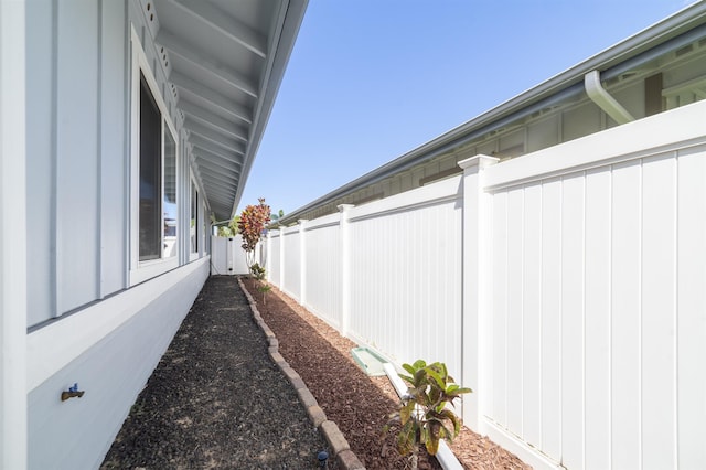 view of side of property featuring fence