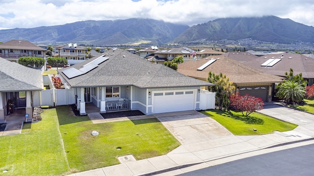 view of front of house featuring a porch, an attached garage, a residential view, roof with shingles, and a mountain view