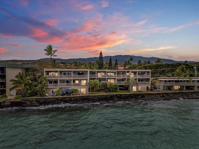 exterior space with a water and mountain view