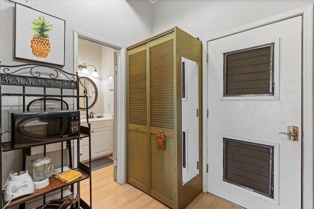 interior space featuring vanity and hardwood / wood-style flooring