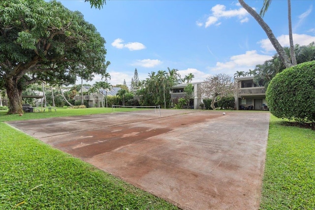 view of community with a yard and tennis court