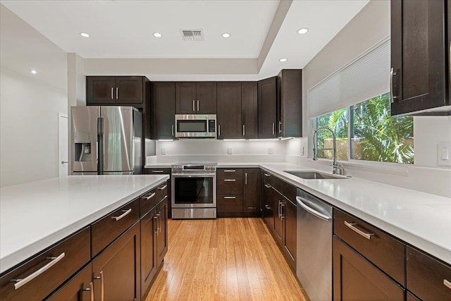 kitchen with light countertops, a sink, stainless steel appliances, and visible vents