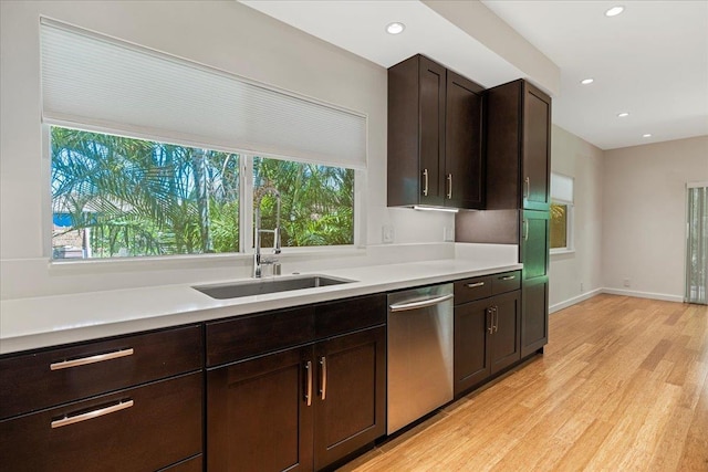 kitchen with plenty of natural light, a sink, light countertops, and dishwasher