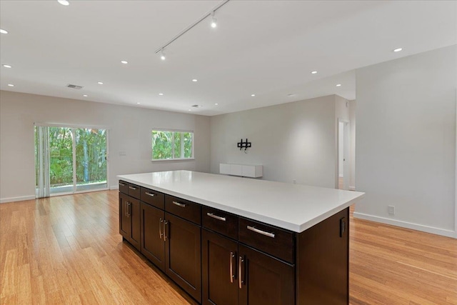kitchen featuring open floor plan, visible vents, and light wood-style floors