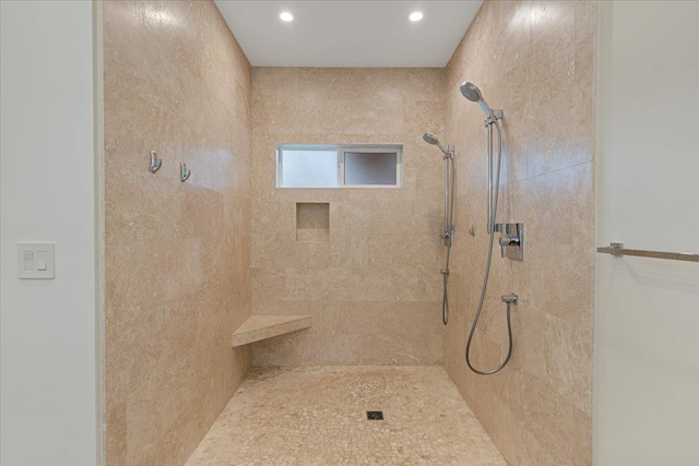 bathroom featuring a tile shower