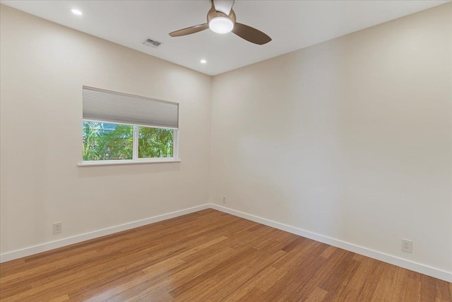 unfurnished room with baseboards, ceiling fan, visible vents, and light wood-style floors
