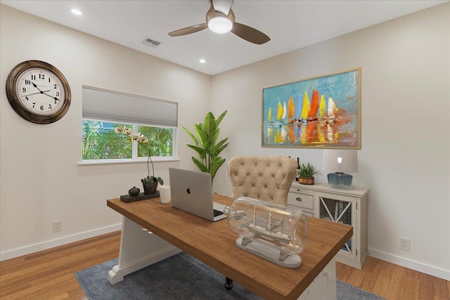 home office with light wood-type flooring, baseboards, ceiling fan, and visible vents
