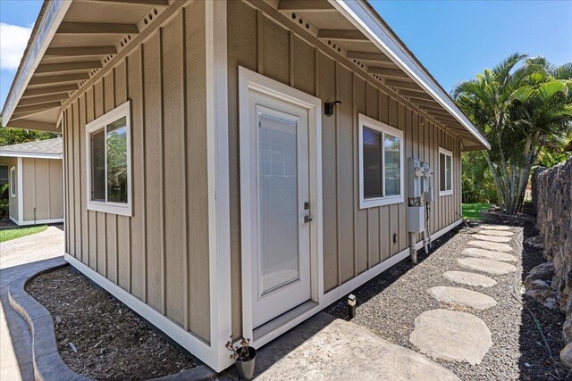 view of side of home featuring fence and board and batten siding
